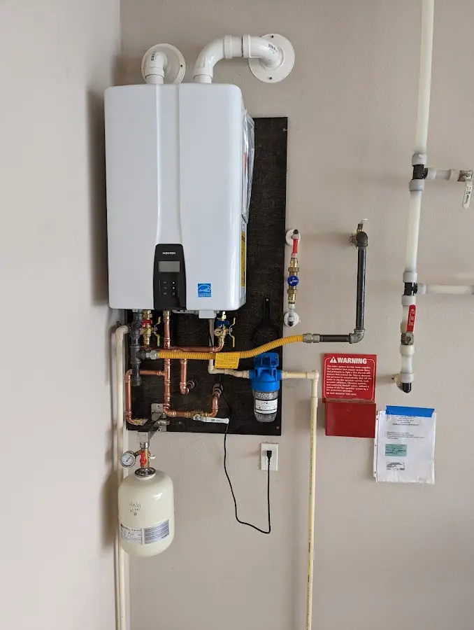 Professional plumber installing copper piping in a Capitol View home